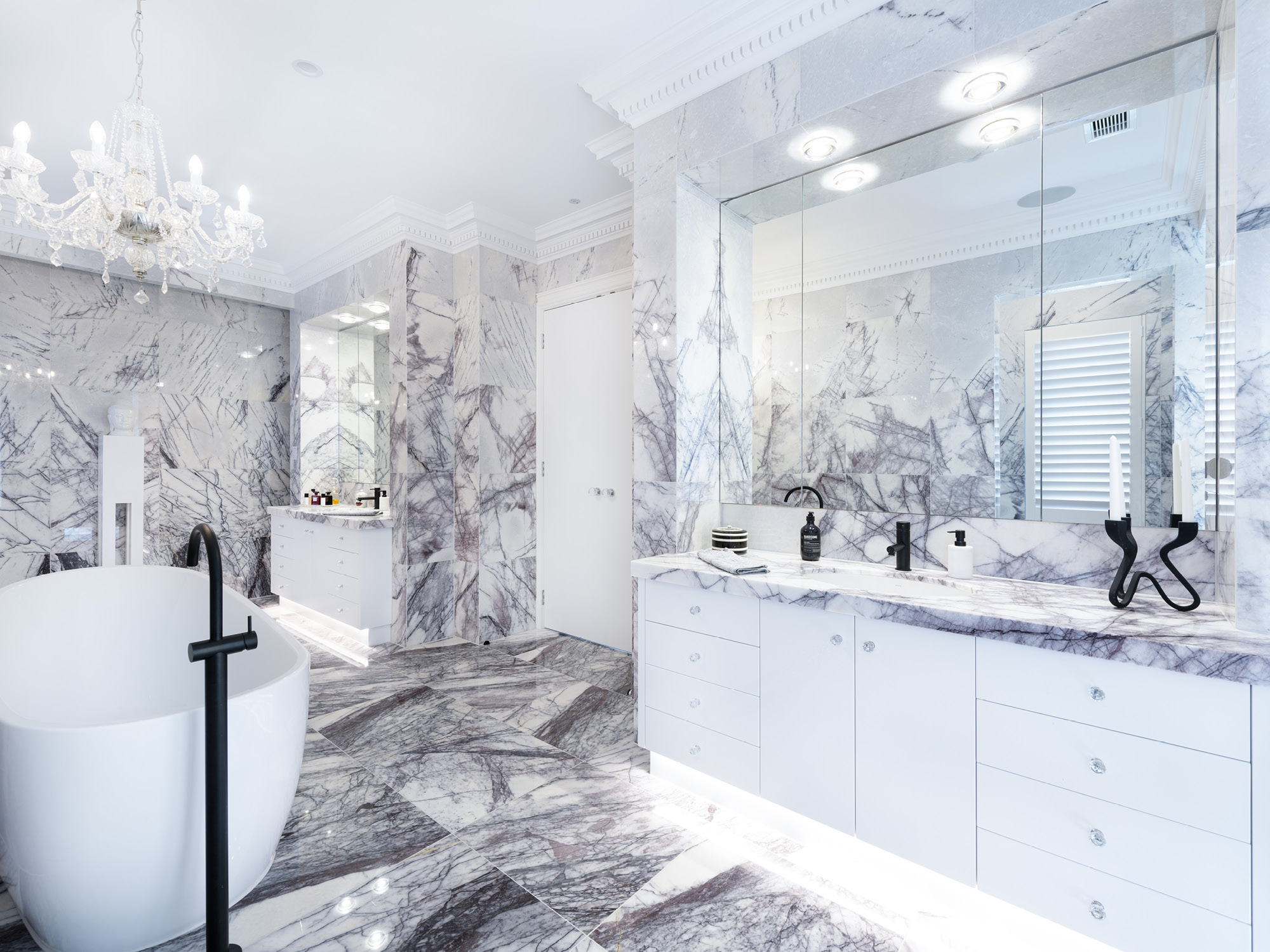 An elaborately tiled marble bathroom.